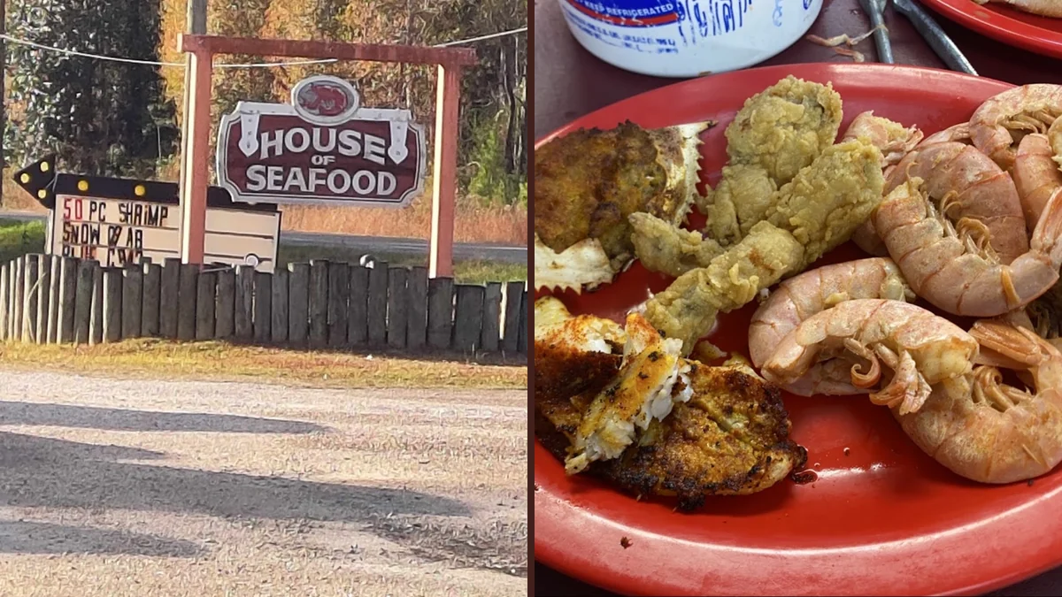 Seafood buffet line with hot trays and serving spoons.