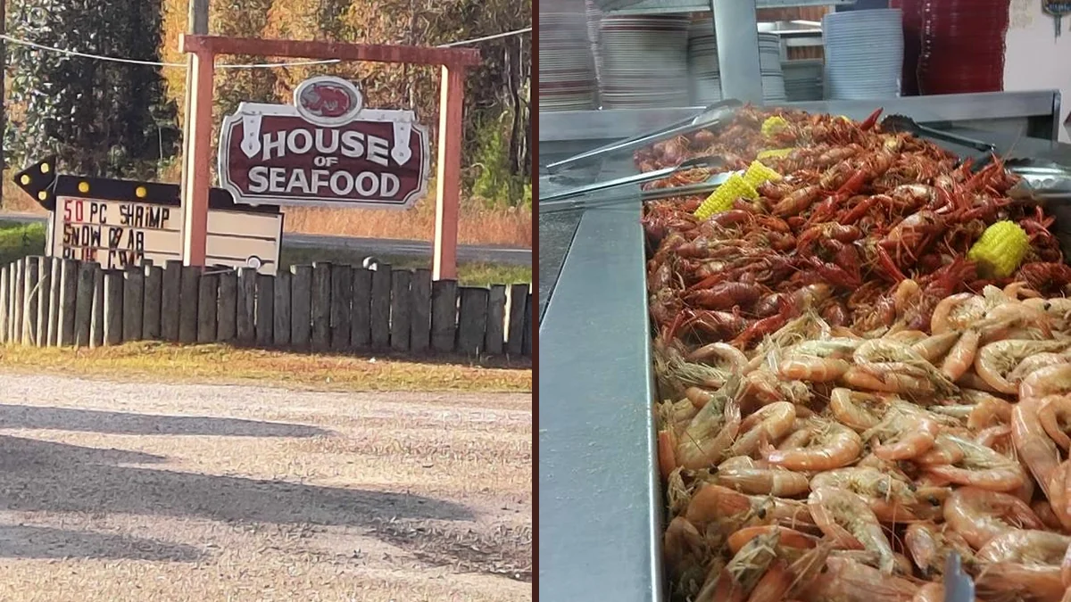 Seafood buffet line with hot trays and serving spoons.